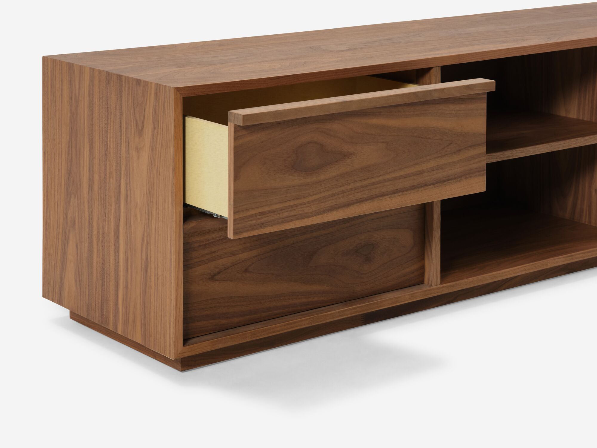 Left detail view of modern walnut tv stand with top drawer open